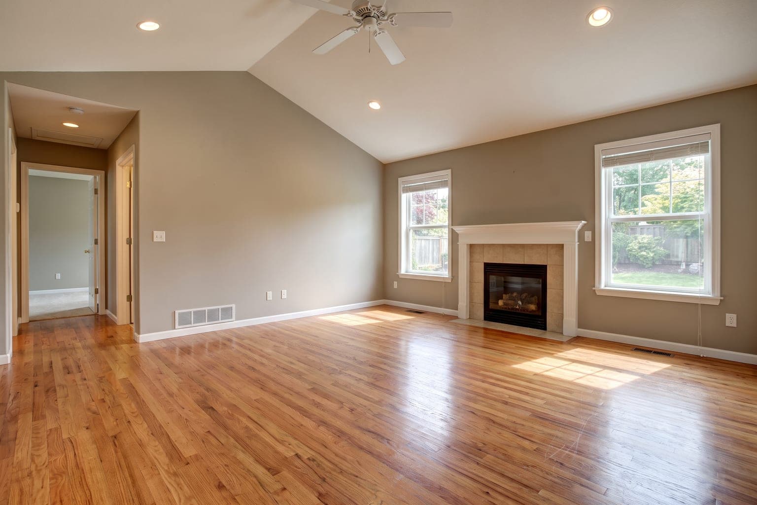 Empty suburban living room with a fireplace, ready for AI virtual staging